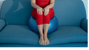 Person sitting on exercise ball on a couch