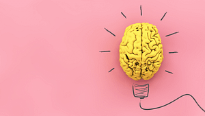 Mockup of a brain with a lightbulb drawing on pink background